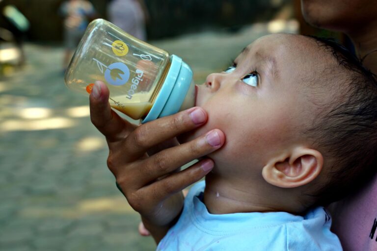 Un bébé boit au biberon en extérieur par forte chaleur (photo d illustration)